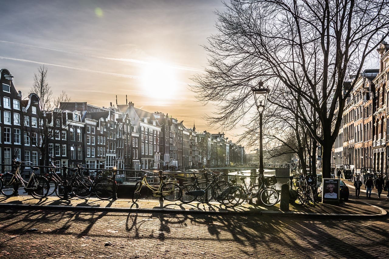 Bikes sitting along a canal in Amsterdam