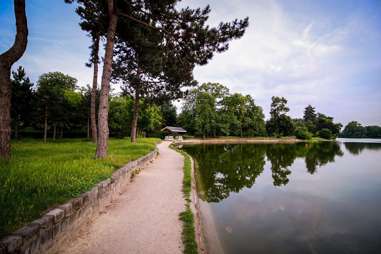 A walking path along a small body of water in Paris.