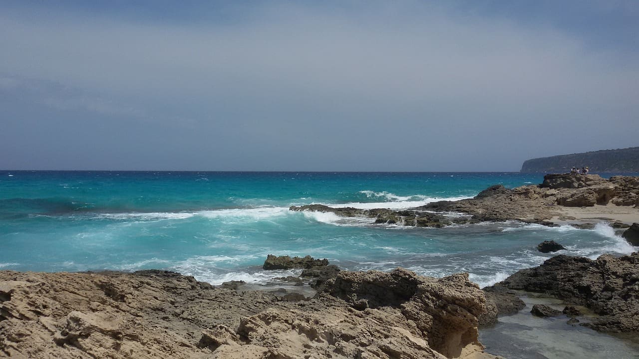 Ocean waves splashing against rocks in Formentera, Spain