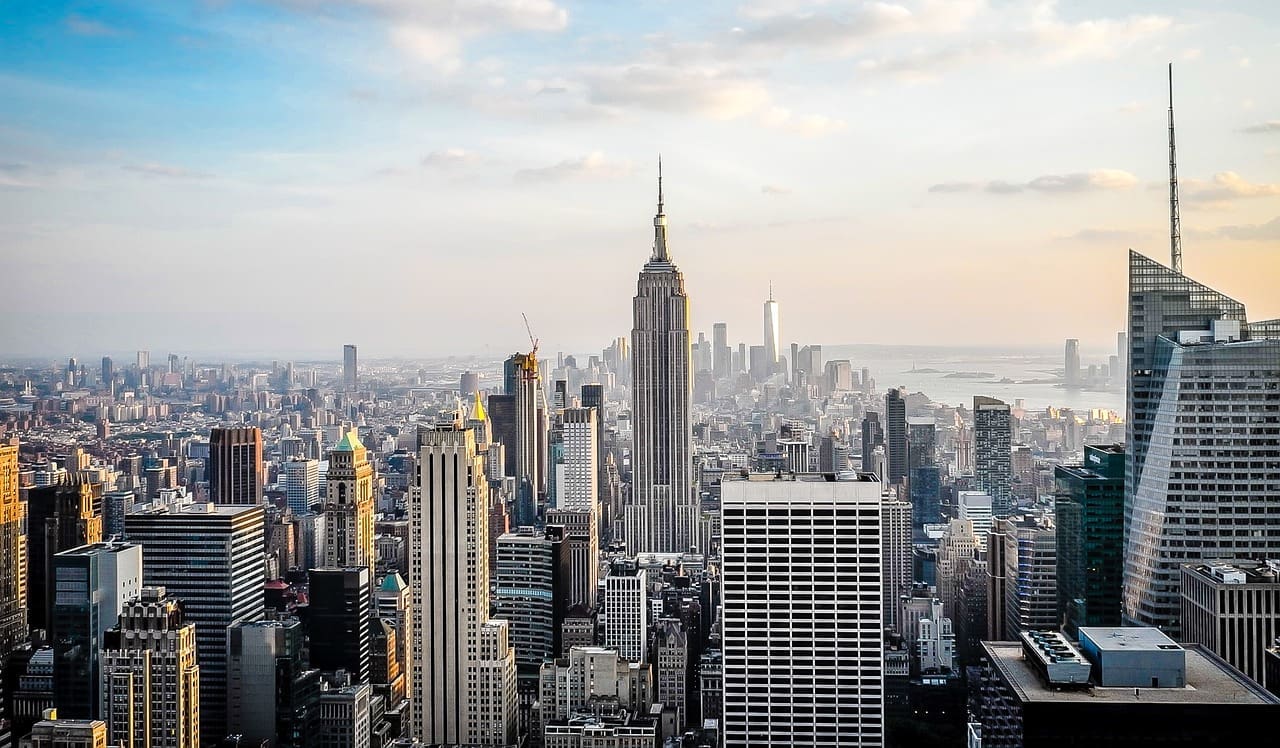 A view of the New York City skyline with The Empire State Building in the foreground.