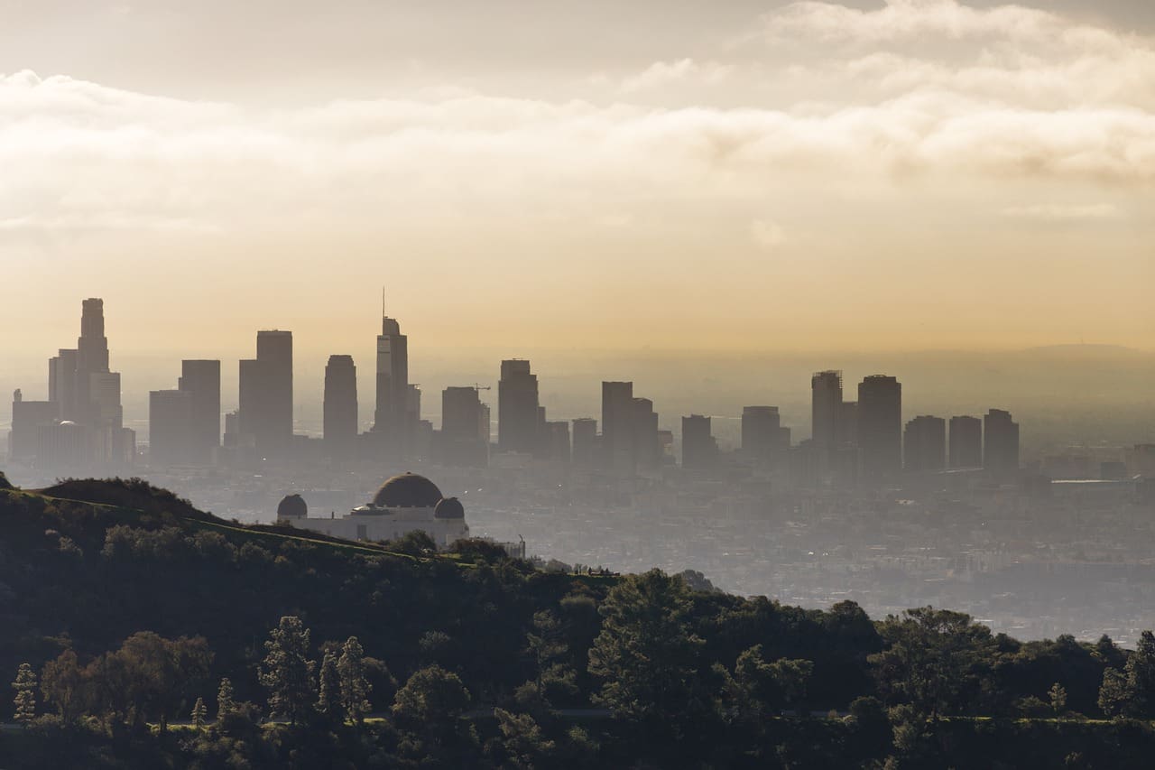 The Griffith Park Observatory with the Los Angeles skyline in the background.
