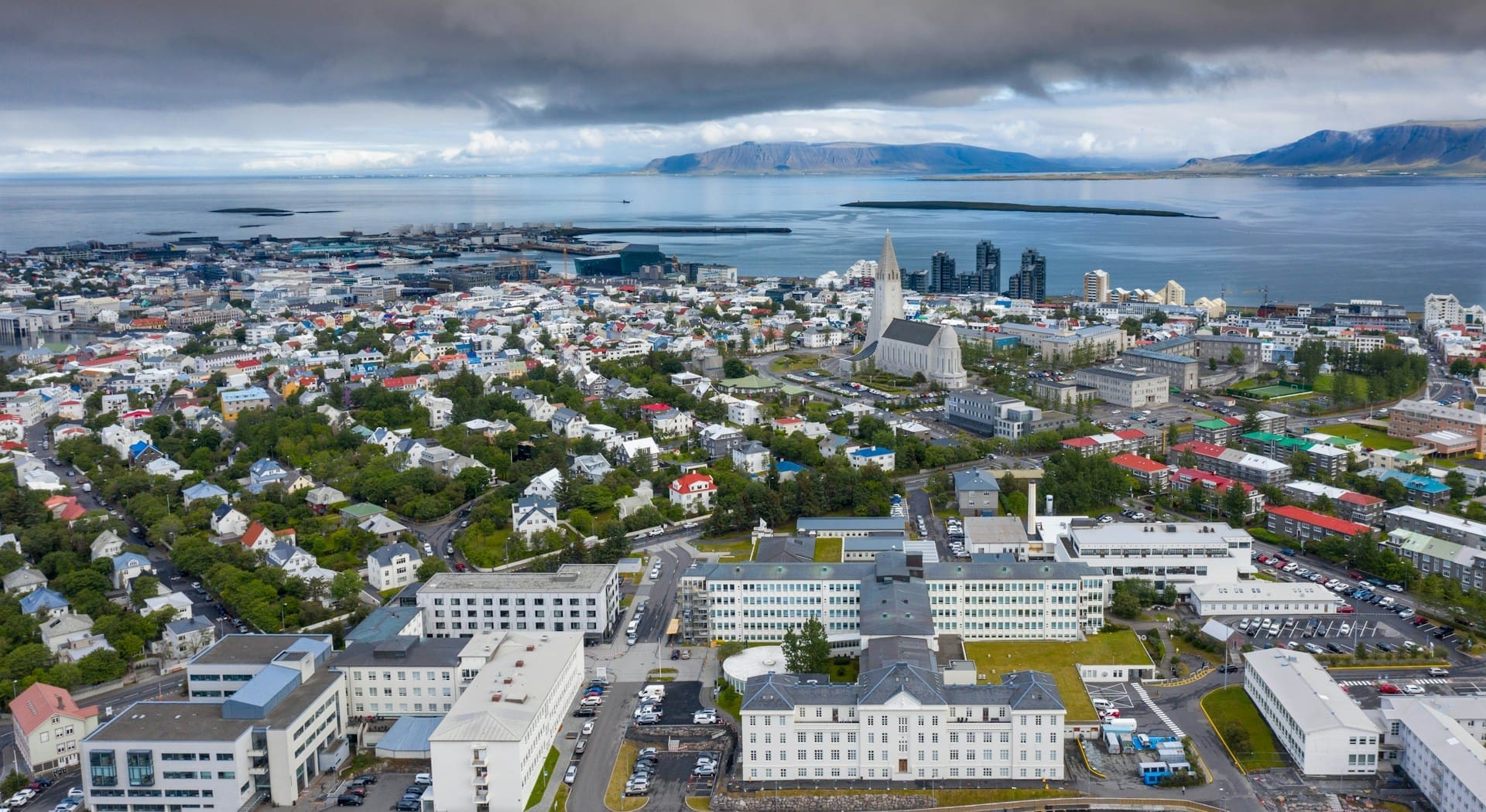 A photo of Reykjavik, Iceland with volcanic mountains in the distance.